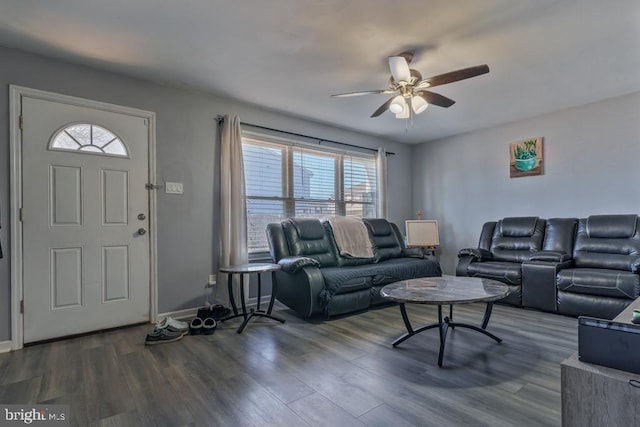 living room with dark wood-style floors, baseboards, and a ceiling fan