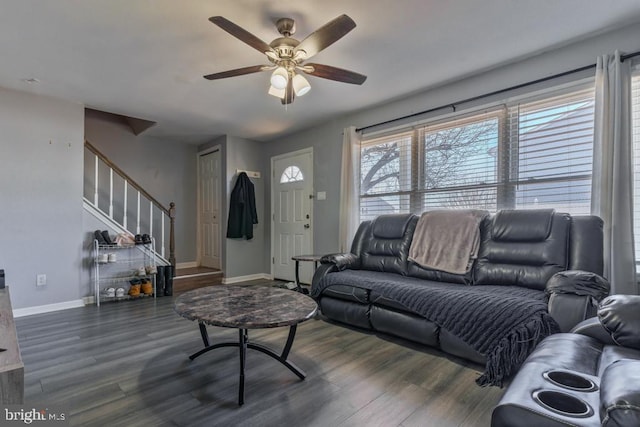 living area with stairway, baseboards, dark wood-style flooring, and ceiling fan