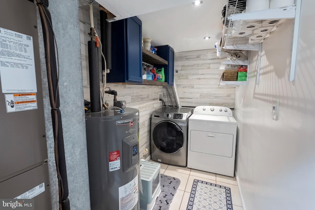 502 Dembytown Rd, Joppa, MD 21085 - clothes washing area featuring light tile patterned floors, washer and dryer, laundry area, electric water heater, and wooden walls