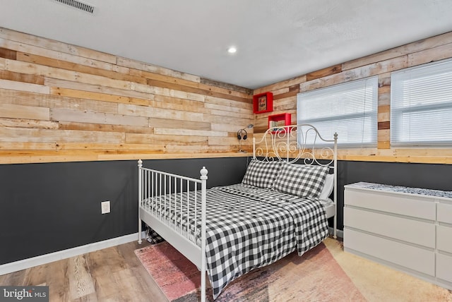 502 Dembytown Rd, Joppa, MD 21085 - bedroom with baseboards, recessed lighting, wood walls, light wood-style floors, and visible vents