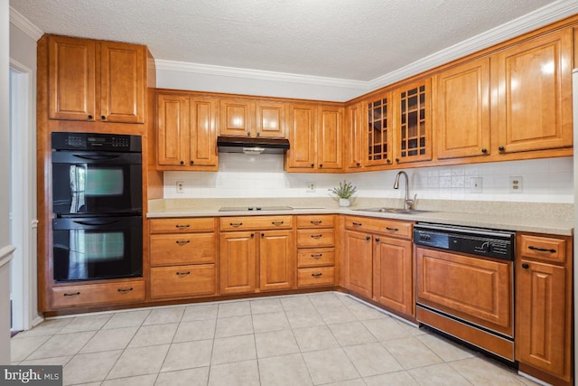 kitchen featuring under cabinet range hood, black appliances, brown cabinetry, and a sink