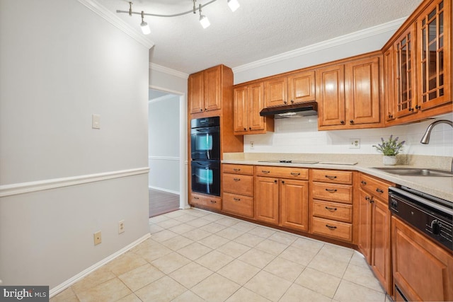 kitchen featuring ornamental molding, a sink, black appliances, light countertops, and under cabinet range hood