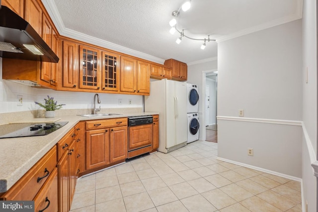 kitchen with paneled dishwasher, a sink, stacked washer and clothes dryer, under cabinet range hood, and black electric stovetop