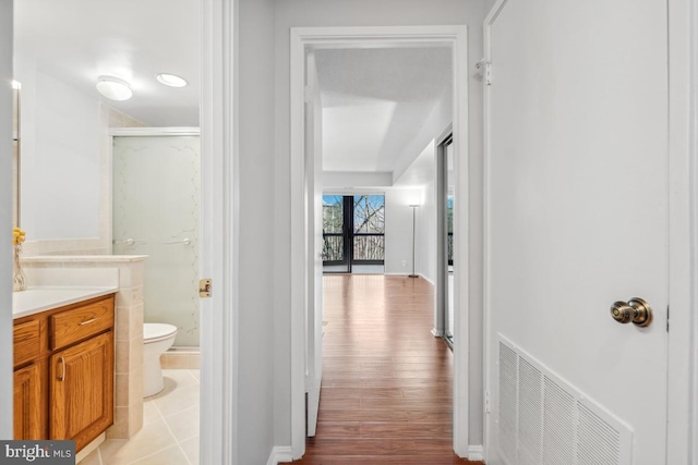 hall featuring visible vents and light wood-type flooring