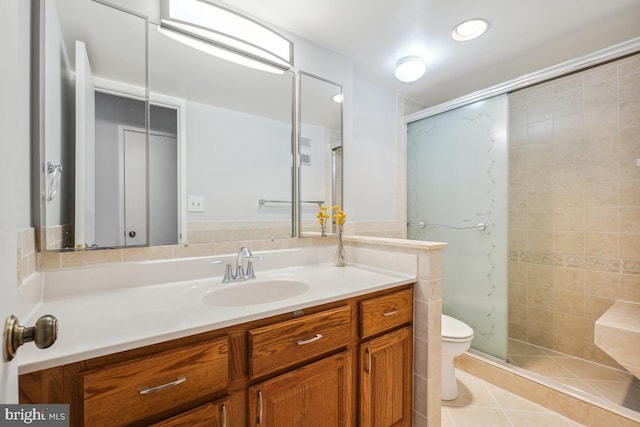 full bath with tile patterned flooring, vanity, a shower stall, and toilet