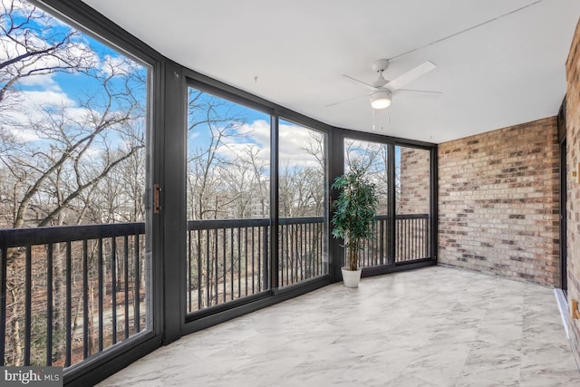 unfurnished sunroom with ceiling fan