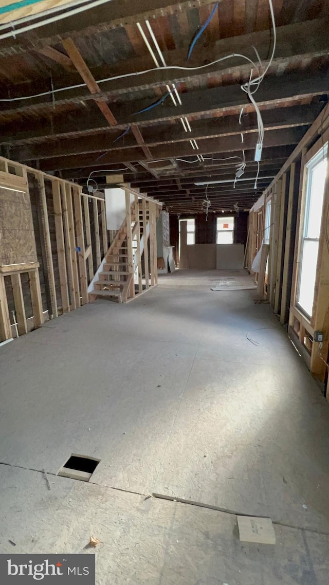 misc room featuring plenty of natural light and stairway