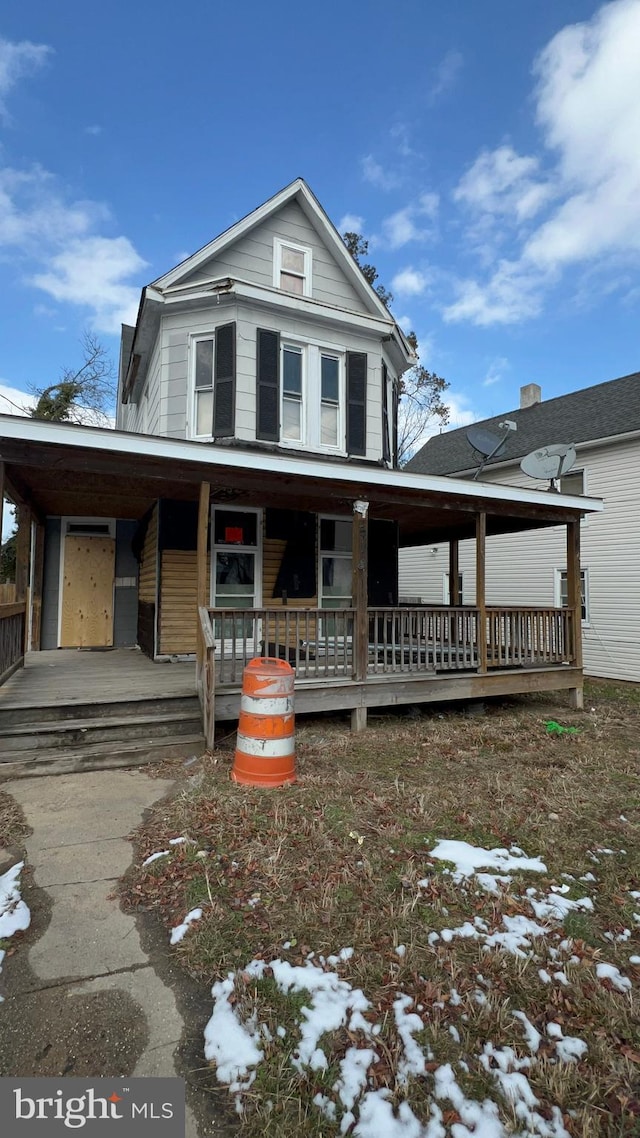 view of front facade with a carport and a porch