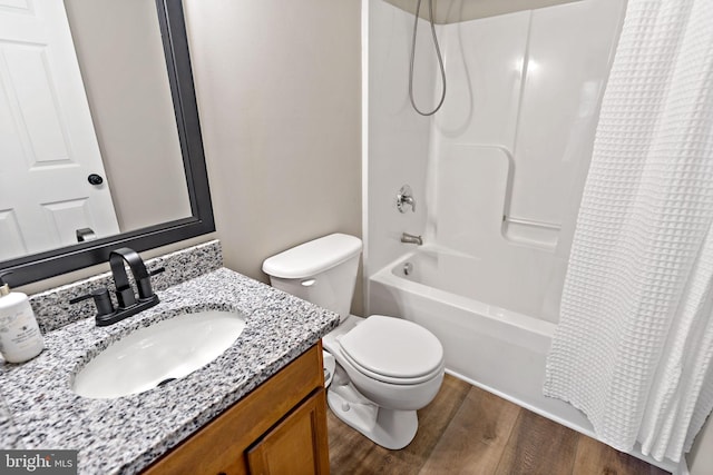 bathroom with vanity, shower / tub combo, toilet, and wood finished floors