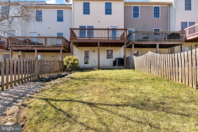 back of house featuring central AC unit, a yard, a fenced backyard, and a wooden deck