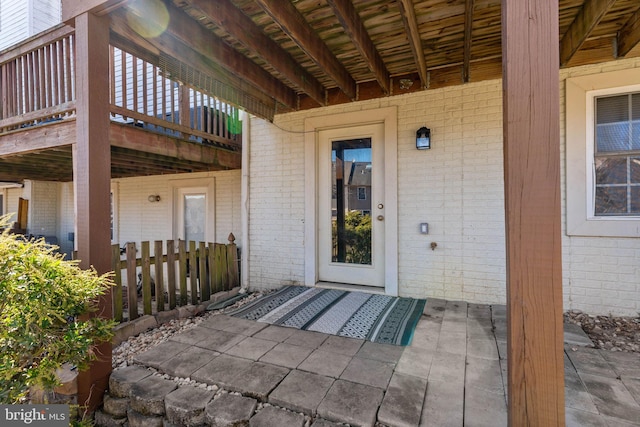 property entrance with brick siding