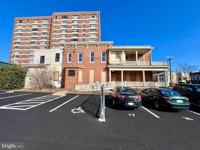 view of building exterior with uncovered parking