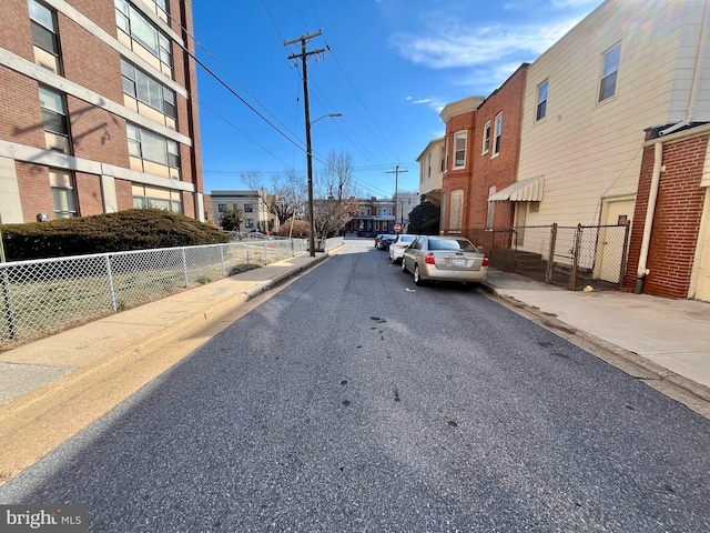 view of road with curbs, sidewalks, and street lighting