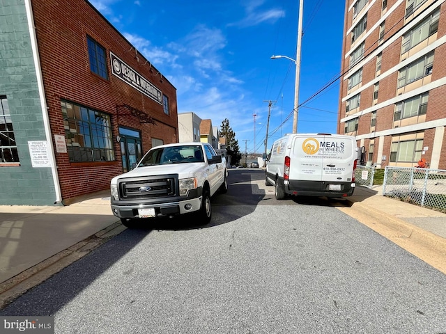 view of road with curbs, street lighting, and sidewalks