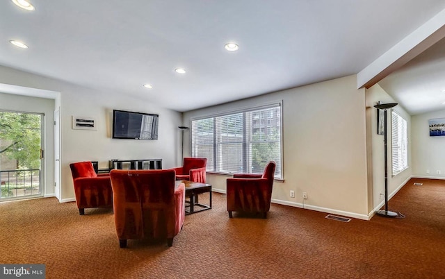 carpeted living area with visible vents, recessed lighting, lofted ceiling with beams, and baseboards