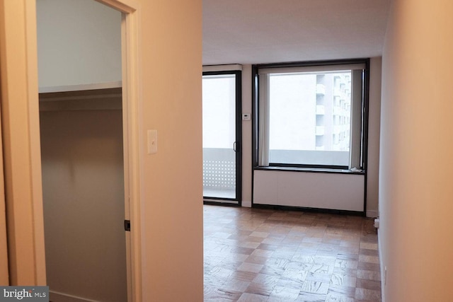 hallway featuring baseboards