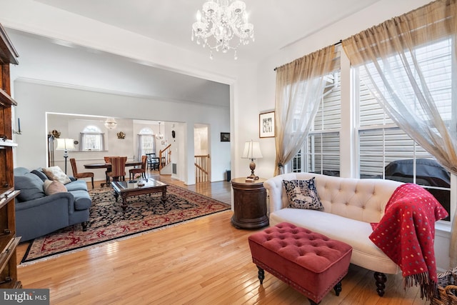 living area featuring a notable chandelier and wood-type flooring