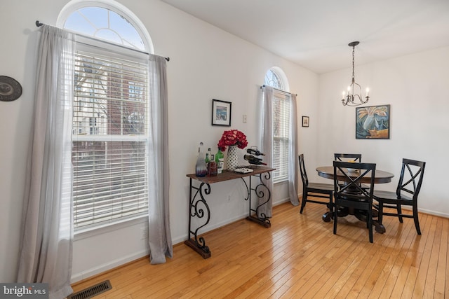 dining area featuring visible vents, plenty of natural light, and light wood-type flooring