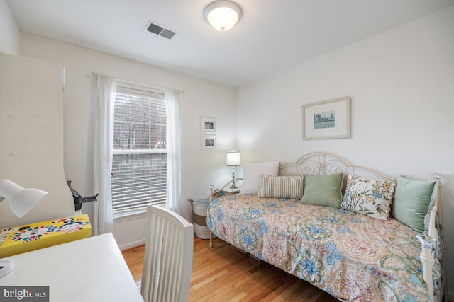 bedroom with wood finished floors and visible vents