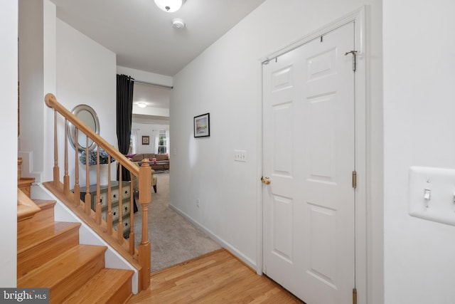 stairs featuring baseboards and wood finished floors