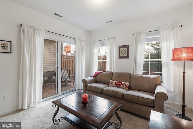 carpeted living area with visible vents and baseboards