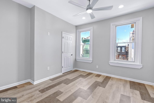 unfurnished room with recessed lighting, baseboards, wood finished floors, and a ceiling fan