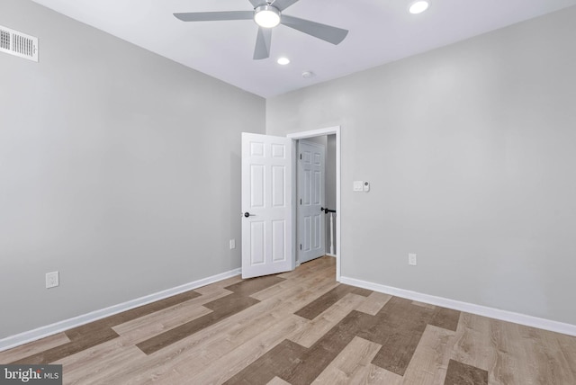 unfurnished room featuring a ceiling fan, wood finished floors, visible vents, baseboards, and recessed lighting