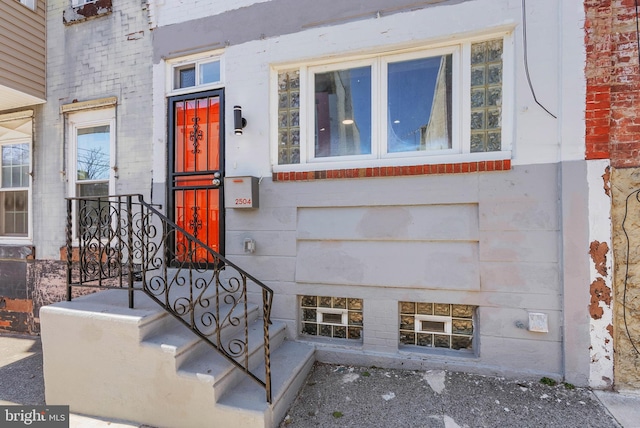 view of exterior entry with brick siding