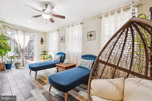 living area featuring a ceiling fan and wood finished floors