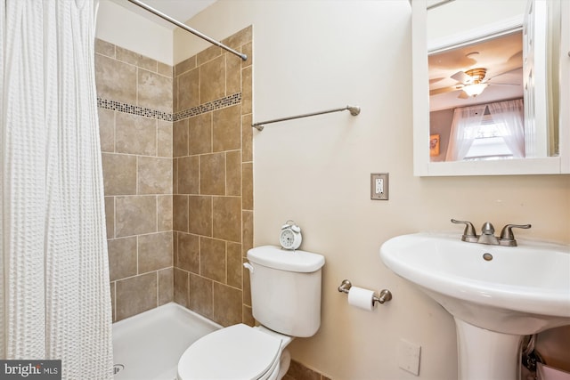 full bath featuring ceiling fan, toilet, a stall shower, and a sink