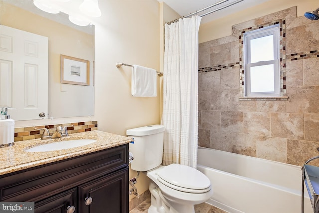 bathroom with vanity, toilet, and shower / bath combo with shower curtain