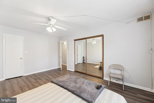 bedroom with visible vents, baseboards, and wood finished floors