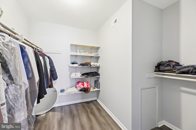 walk in closet featuring wood finished floors and visible vents