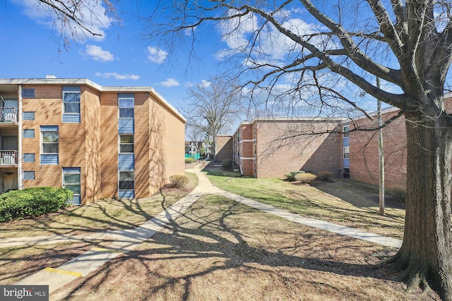 view of property exterior featuring brick siding