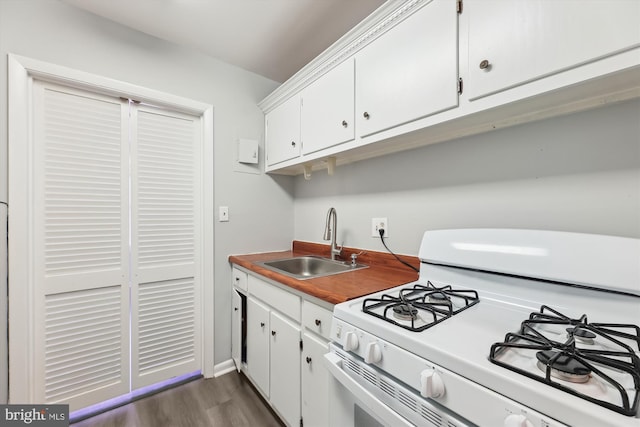 kitchen with white cabinetry, dark wood finished floors, white gas range oven, and a sink