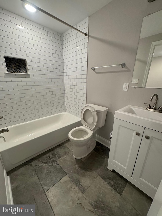 full bathroom with toilet, vanity, baseboards, and washtub / shower combination