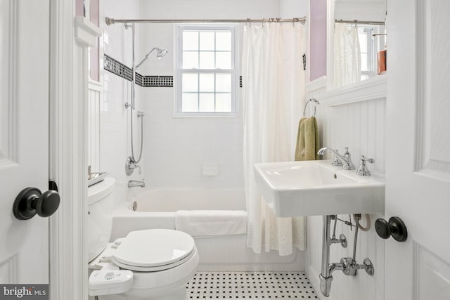 full bathroom featuring shower / tub combo, toilet, and a sink