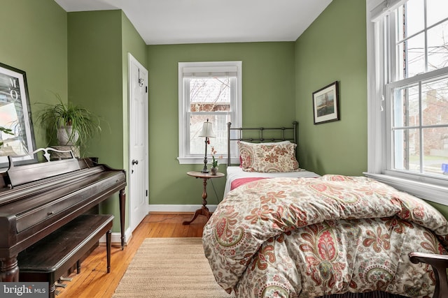 bedroom featuring baseboards and wood finished floors