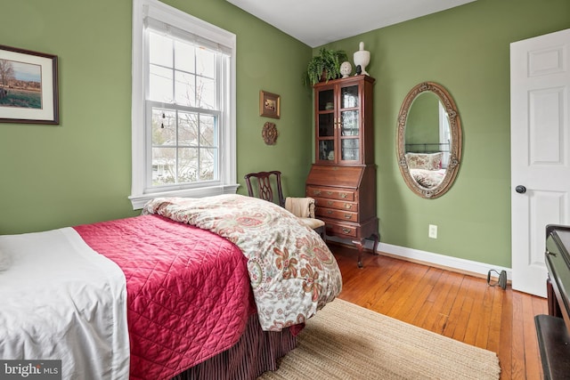 bedroom featuring light wood-type flooring and baseboards