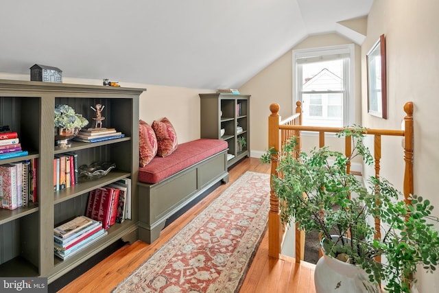 bedroom with light wood-type flooring and lofted ceiling