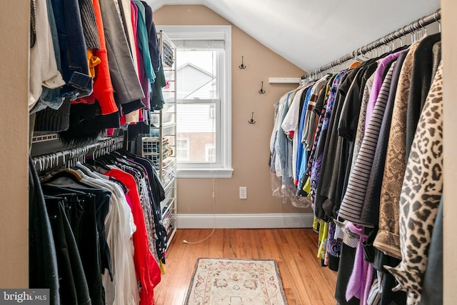 walk in closet featuring vaulted ceiling and wood finished floors