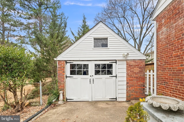 garage with a shed and fence