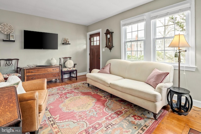 living room featuring baseboards and wood finished floors