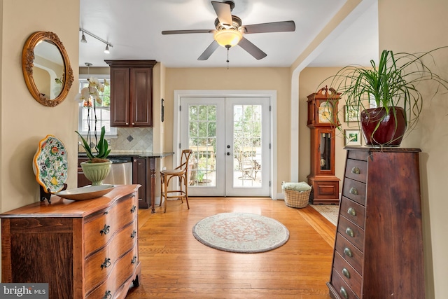 entryway featuring a wealth of natural light, french doors, light wood-style flooring, and ceiling fan