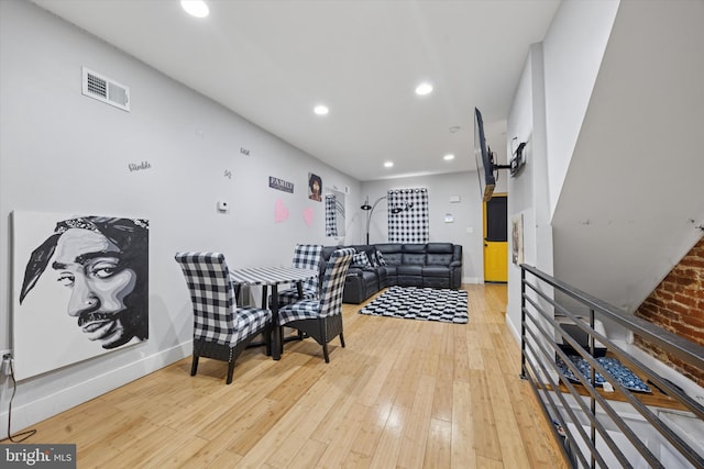 living area with recessed lighting, visible vents, baseboards, and light wood finished floors