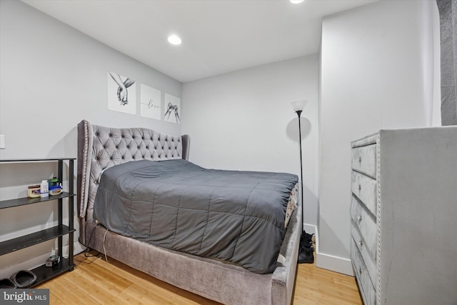 bedroom with recessed lighting and wood finished floors