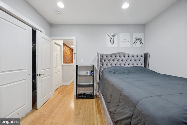 bedroom with recessed lighting, light wood-style flooring, and baseboards