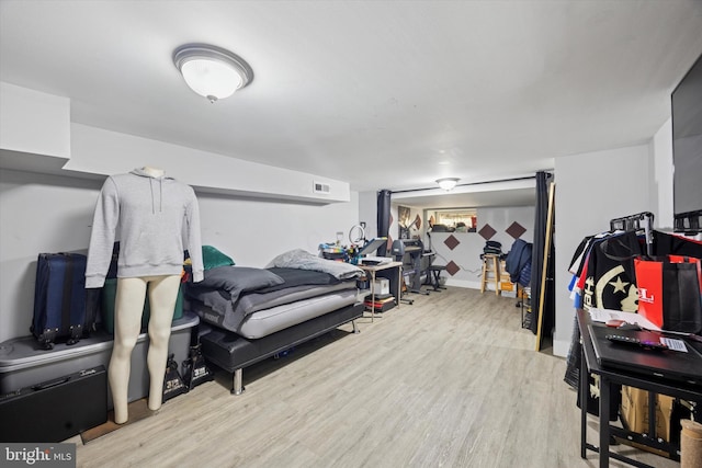 bedroom featuring visible vents, baseboards, and wood finished floors