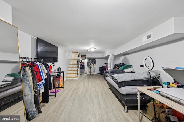 bedroom with visible vents and wood finished floors