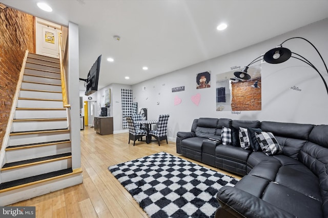 living room with stairway, recessed lighting, light wood-style flooring, and baseboards